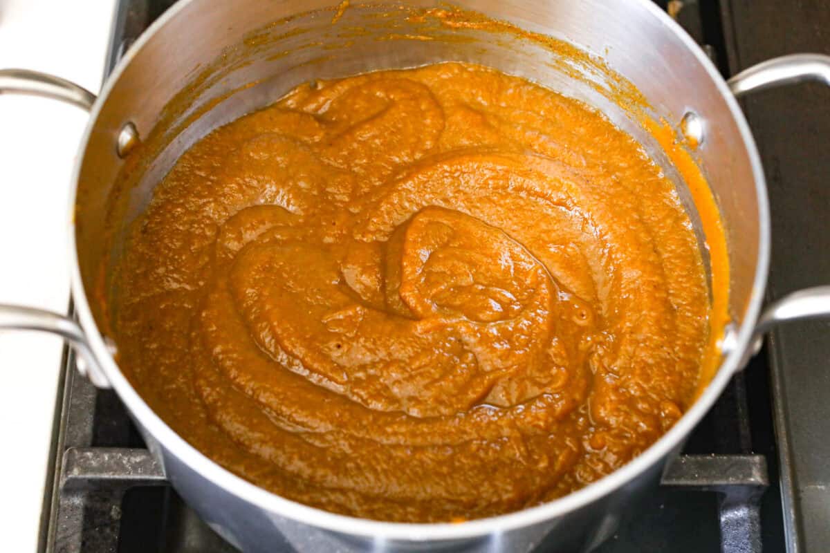 This Harry Potter Pumpkin Juice will transport you to a magical ride on the Hogwarts Express or eating lunch with your friends in the great hall. Bursting with warm, cozy fall flavor, you will love feeling part of the wizarding world of Harry Potter with this magical drink. Overhead shot of puree spices and water mixture mixed together in the pan.