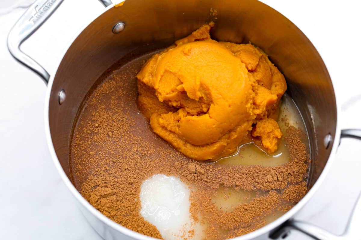 This Harry Potter Pumpkin Juice will transport you to a magical ride on the Hogwarts Express or eating lunch with your friends in the great hall. Bursting with warm, cozy fall flavor, you will love feeling part of the wizarding world of Harry Potter with this magical drink. Overhead shot of pumpkin puree, water, sugar and spices in a sauce pan.