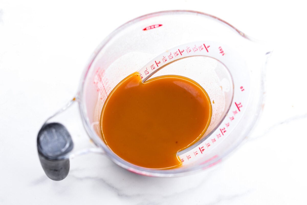 This Harry Potter Pumpkin Juice will transport you to a magical ride on the Hogwarts Express or eating lunch with your friends in the great hall. Bursting with warm, cozy fall flavor, you will love feeling part of the wizarding world of Harry Potter with this magical drink. Overhead shot of strained pumpkin juice in a measuring cup.